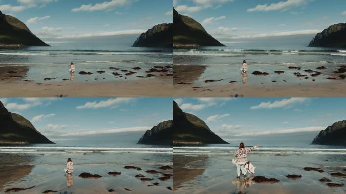 无人机放大画面，显示一个十几岁的女孩在玩海浪，一只白色的大狗也加入了她的行列