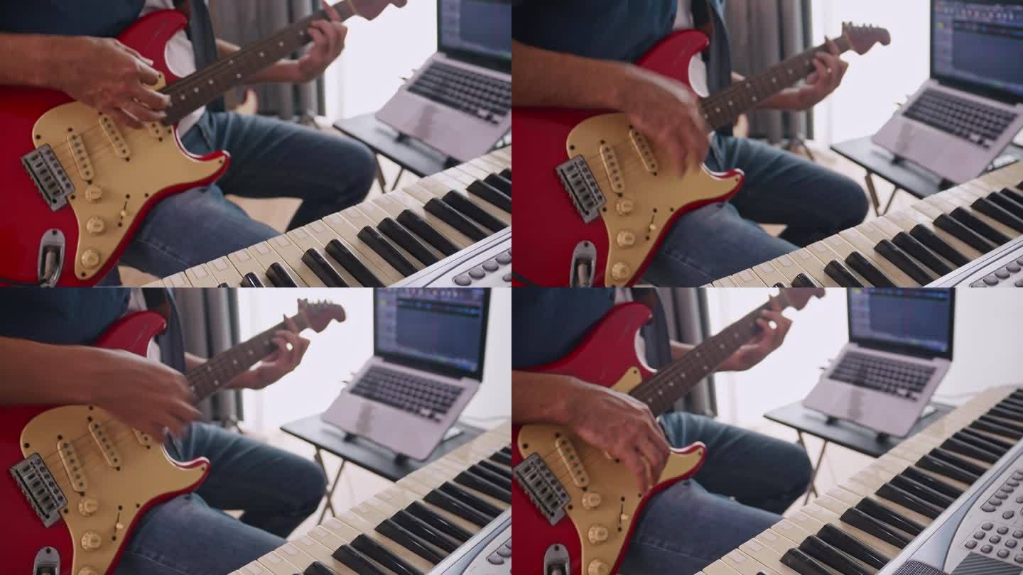一个音乐家在家里的数码录音室录制电吉他。作曲家正在使用现代设备来创作旋律。