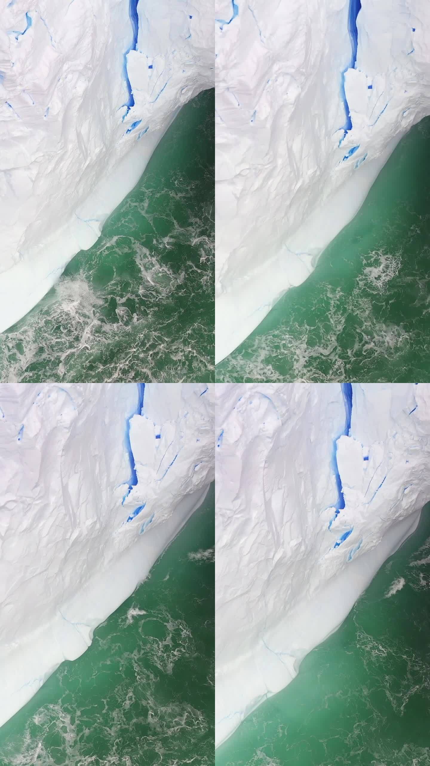 南极海洋巨大的白色冰山拱下爆发的垂直视像波。