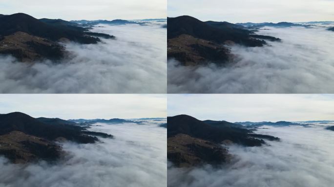 飞过山顶的云层。山峰高耸，清晨日出，自然景观优美