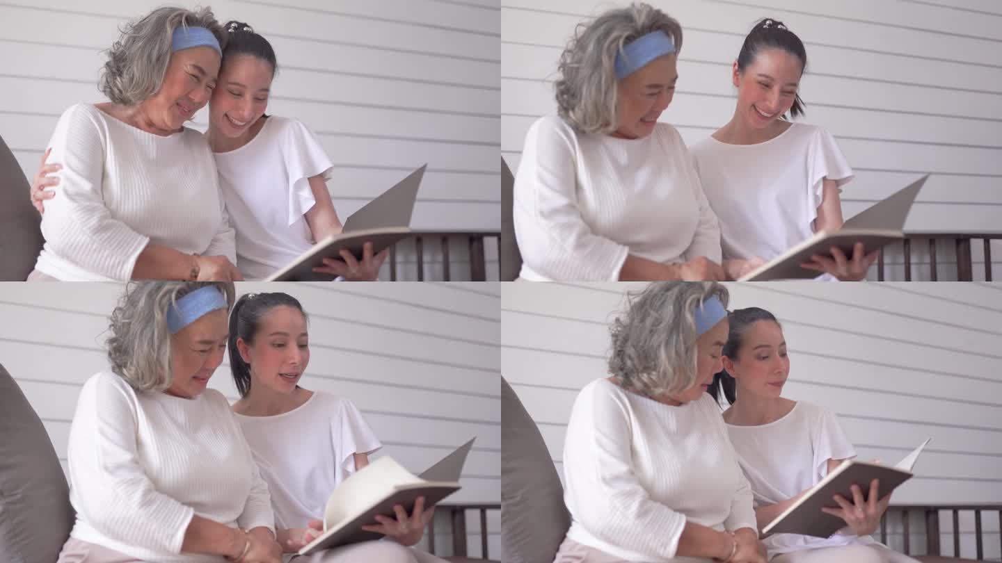 亚洲老年妇女和女儿在家里看书