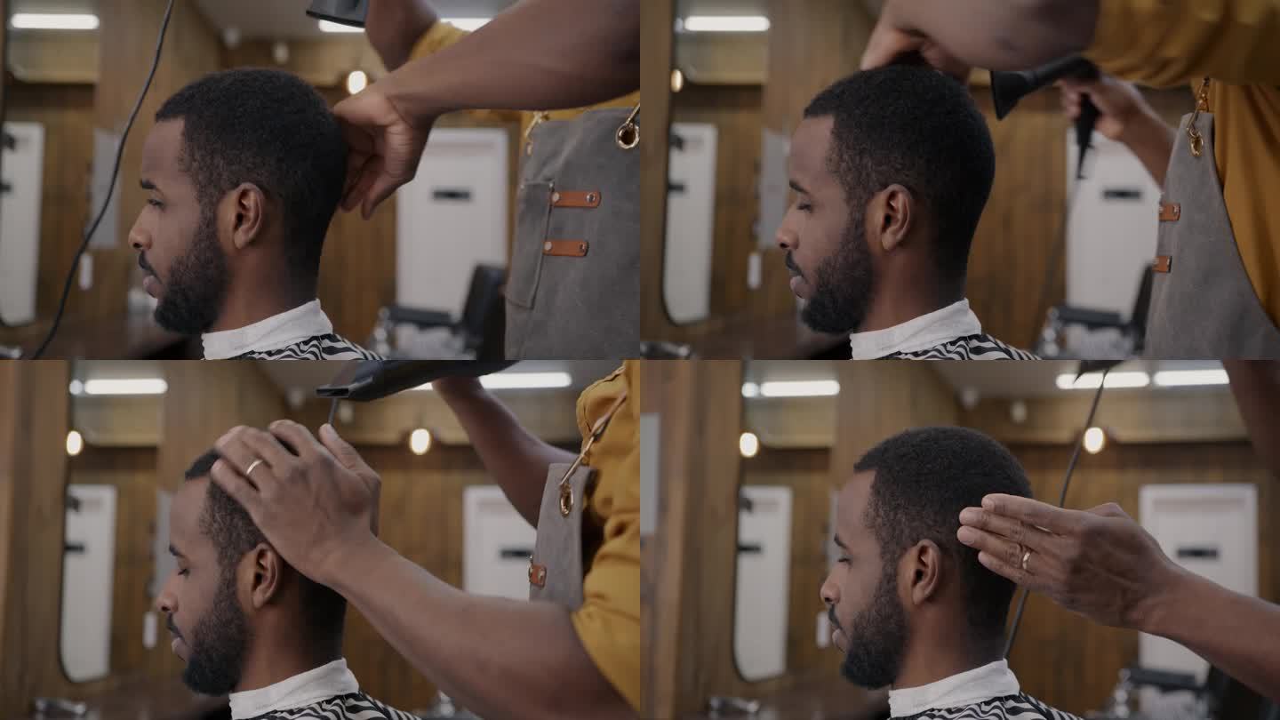 非裔美国人在理发店用现代吹风机吹干头发的特写