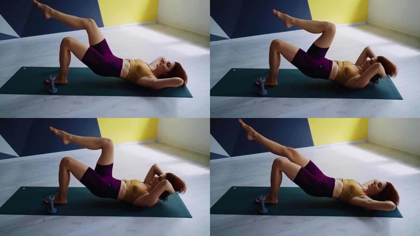 健身房里的有氧和体操锻炼，成年女性躺在地板上做运动