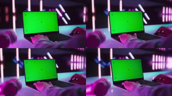 一名匿名玩家在笔记本电脑上玩在线视频游戏，模拟绿屏显示。人坐在一个房间与未来的霓虹灯设计