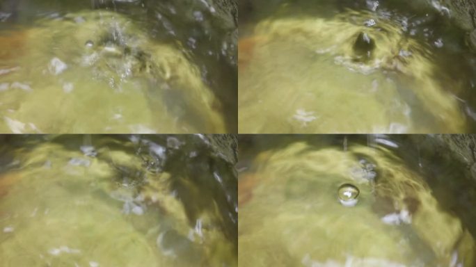 水滴在水中。水的振动像丝圈一样在水中运动。倒水