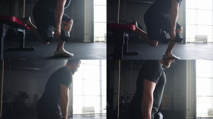 在健身中心进行力量训练，肌肉发达的人进行重量训练，单腿深蹲