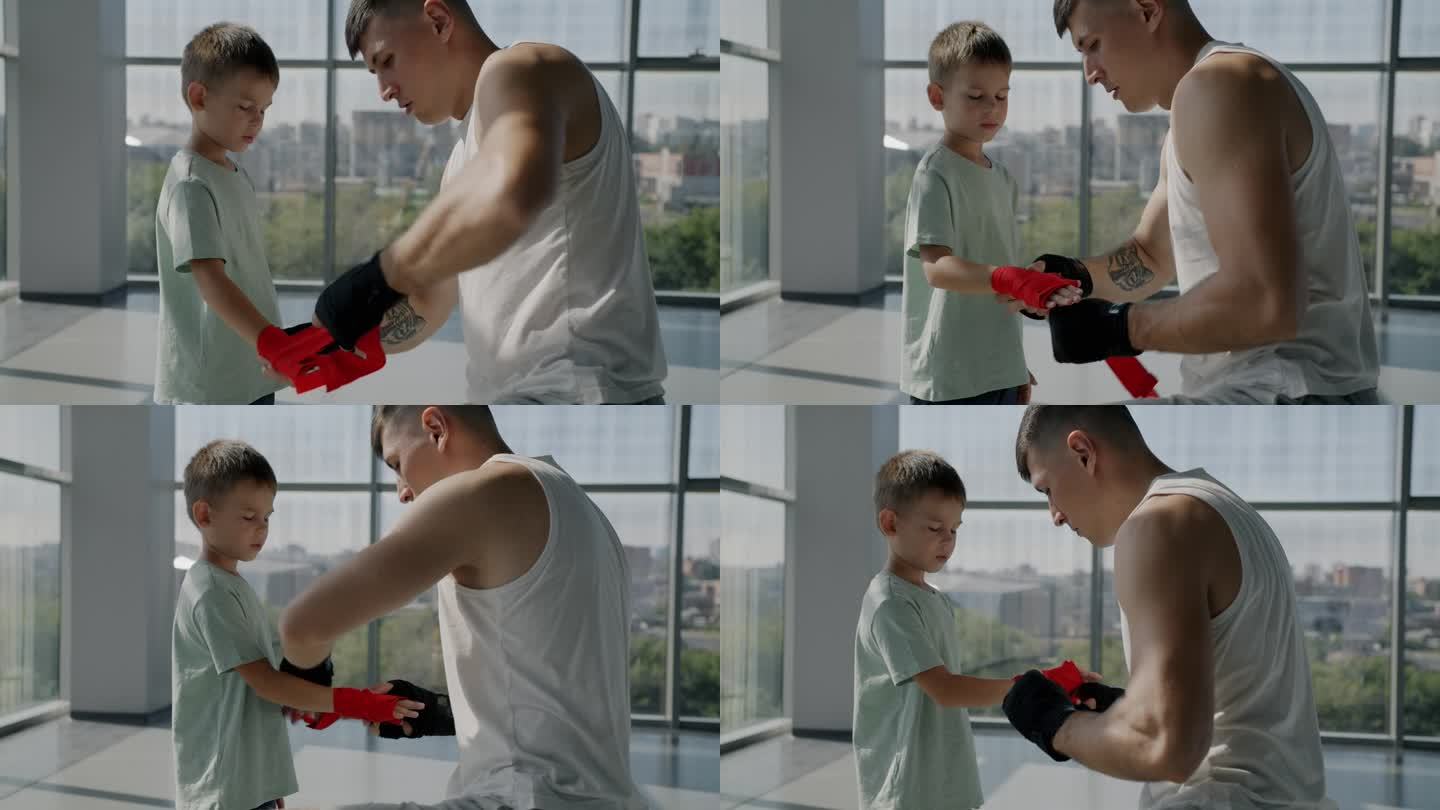 拳击手父亲和小儿子在室内体育馆准备进行拳手保护训练