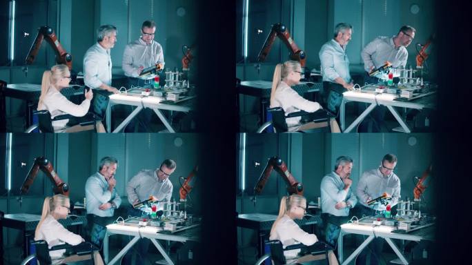 残疾技术人员和她的同事们正在一个现代化的实验室里研究机器人