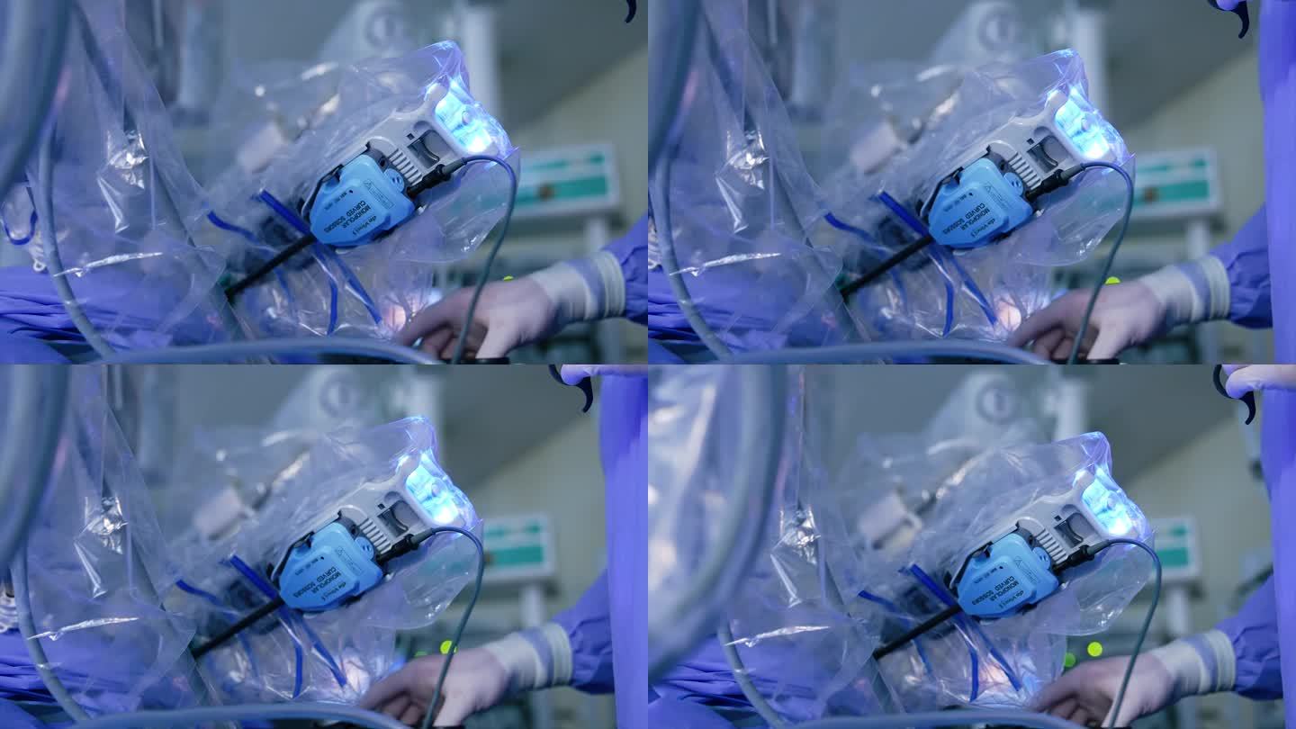 达芬奇机器人的一部分被涂上了塑料。医务人员站在设备旁边监视手术过程。