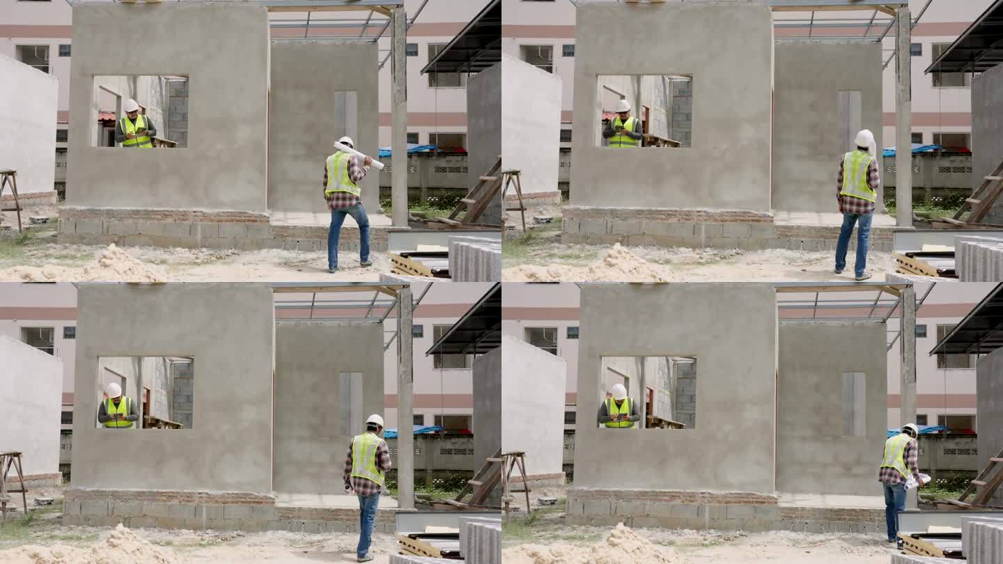 亚洲建筑师和工程师正在检查在建房屋的结构。工作时佩戴绿色反光背心和安全帽，确保安全。多民族人民的合作