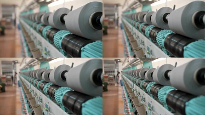 近距离的纱线线轴。纱线制作工艺。线生产。纺织厂设备。纺织工厂。纺纱生产。