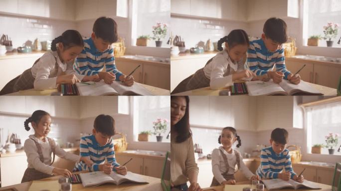 韩国家庭在厨房里的照片:可爱的孩子们在妈妈准备午餐的时候陪伴着她。他们在画画和上色，而他们的妈妈正在