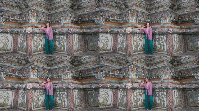 女子手持白香花站在华润寺宝塔的背景上