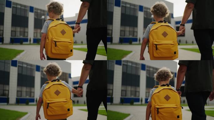 上学，小男孩背着书包，牵着爸爸的手，走在校园里，后景
