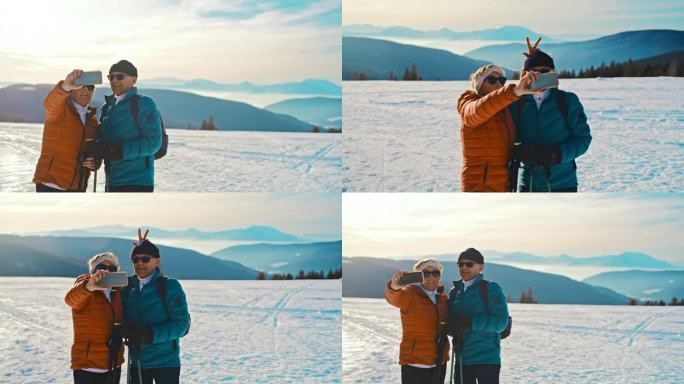 一对老年夫妇在雪地里拿着手机自拍，玩得很开心