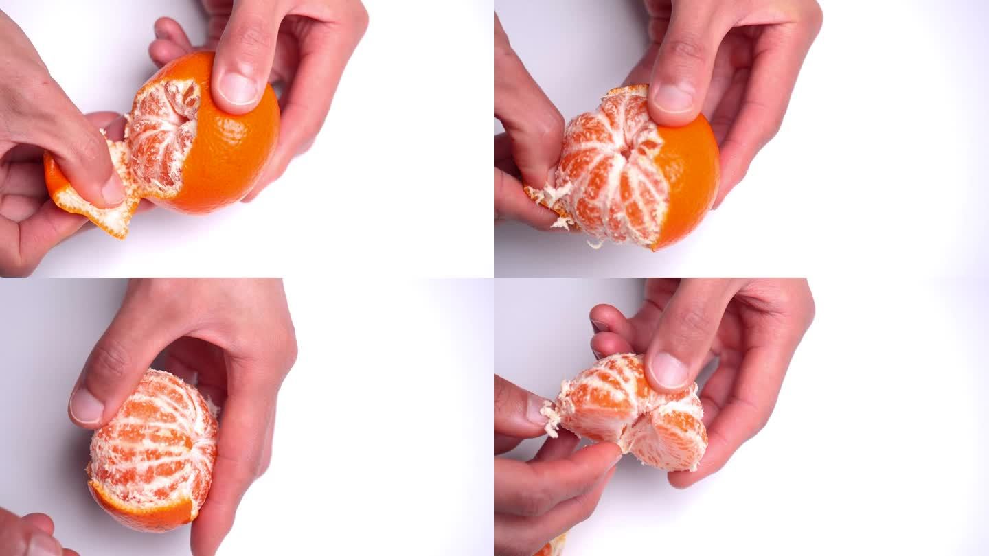 一个白色背景下橘子剥皮的4K视频。
