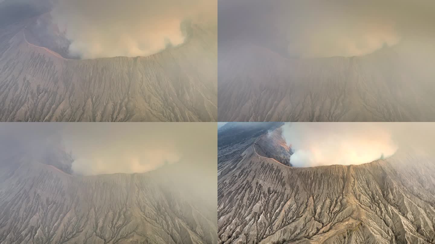 空中无人机拍摄的火山喷发日落场景，被云、雾和烟包围的Bromo火山与塞默鲁山、Batok和Widod