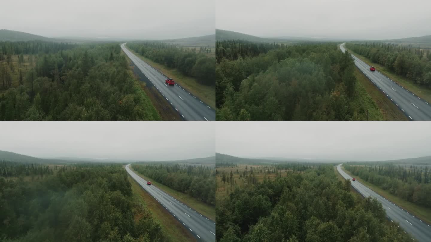 下雨天，无人机跟随红色SUV行驶在野外的道路上。