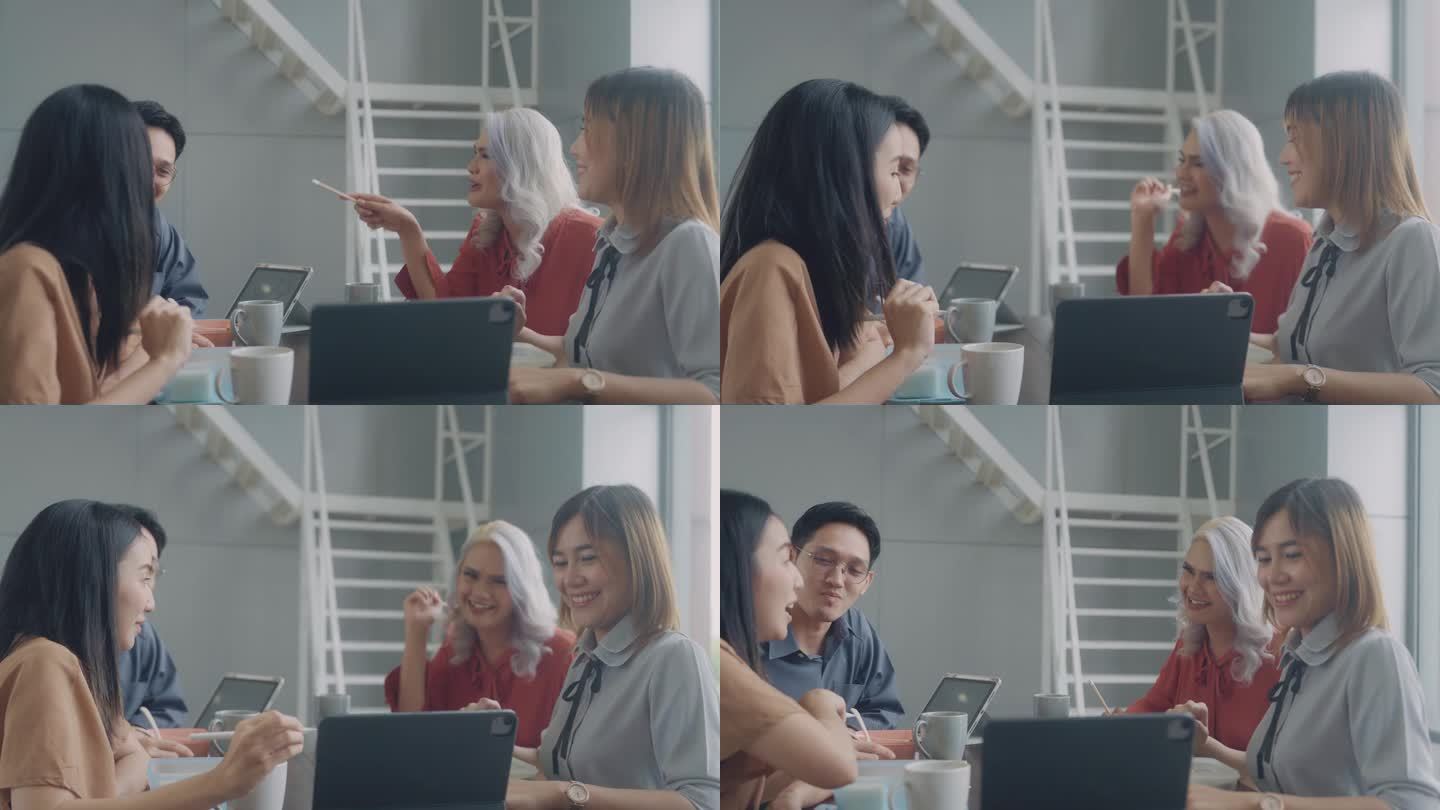 一组同事使用平板电脑工作，并在午餐时与朋友谈论项目。