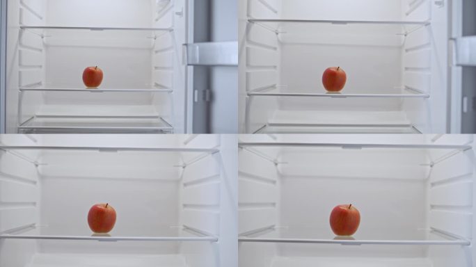 在冰箱的架子上有一个红苹果