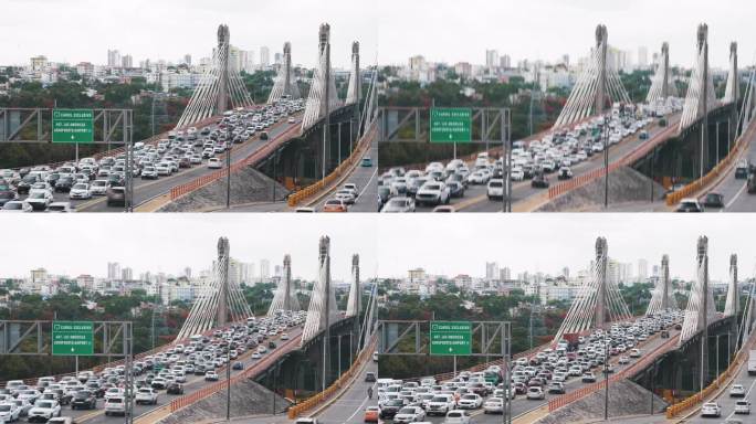 在圣多明各埃斯特的胡安博世大桥上，许多汽车和卡车在日落高峰期的时间间隔。模糊运动城市交通堵塞的背景