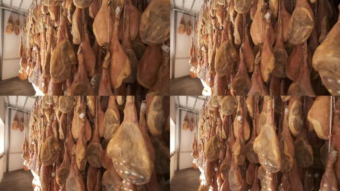 雅蒙塞拉诺猪腿厂悬挂着伊比利亚火腿腿。伊比利亚火腿的加工过程