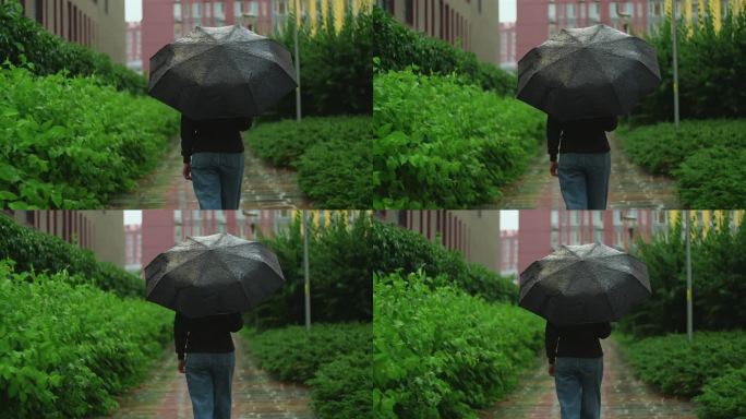 打着伞的女人在雨中行走。阴雨的夏日下着大雨，女孩撑着伞走在潮湿的道路上穿过城市。慢镜头