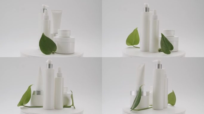 瓶子与绿色叶子旋转美容治疗在白色的背景