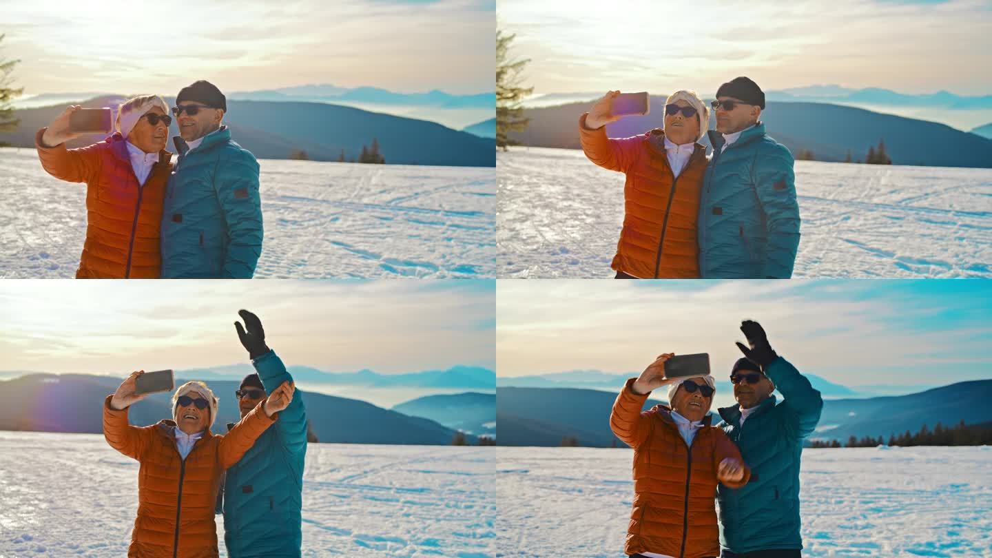 夕阳下，一对老年夫妇在雪地里拿着手机自拍