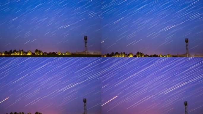 星线在乡村景观水塔的背景上移动。4k超延时在天空中惊人的不寻常的星星效果。夜空中的星迹。曝光。柔和的
