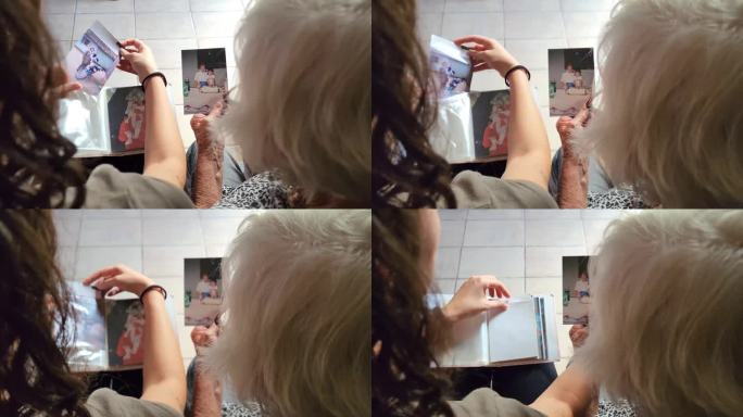 奶奶和孙女把两人的老照片放进相册