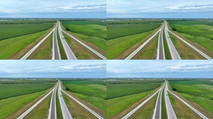 高速公路穿过美国中西部广阔的农田。夏季，卡车和汽车行驶在州际高速公路上，周围环绕着数英里的农田和田野