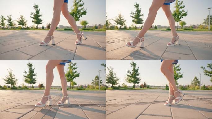 穿着高跟凉鞋的美女腿优雅地漫步在阳光城市公园