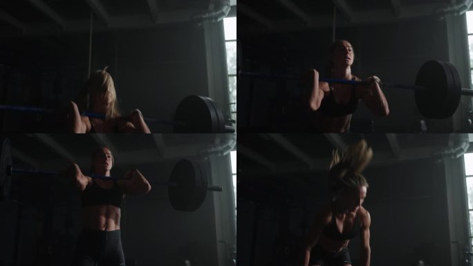 强壮的女运动员在健身房举重杠铃，在黑暗健身俱乐部举重和硬举训练