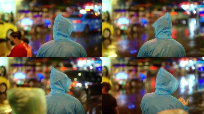 一个年轻人站在雨中的路上