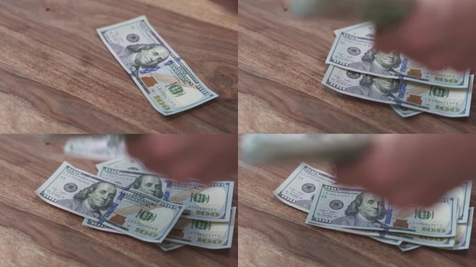 百元大钞掉在桌子上的慢镜头