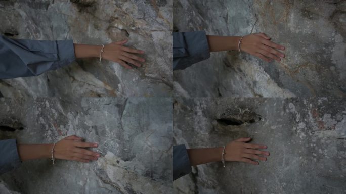 小女孩的手轻轻地摸着岩壁，向前移动。