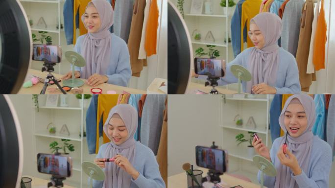 美丽的穆斯林女孩在社交媒体平台上直播故事自拍在家化妆示范。穆斯林女博主教化妆用智能手机录制视频。
