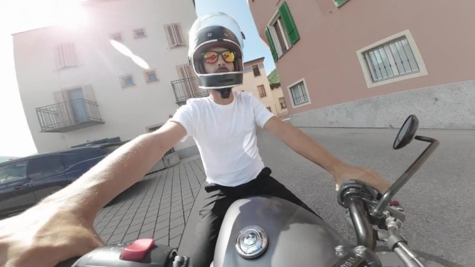 动作摄影机拍摄的男子在阳光下骑摩托车