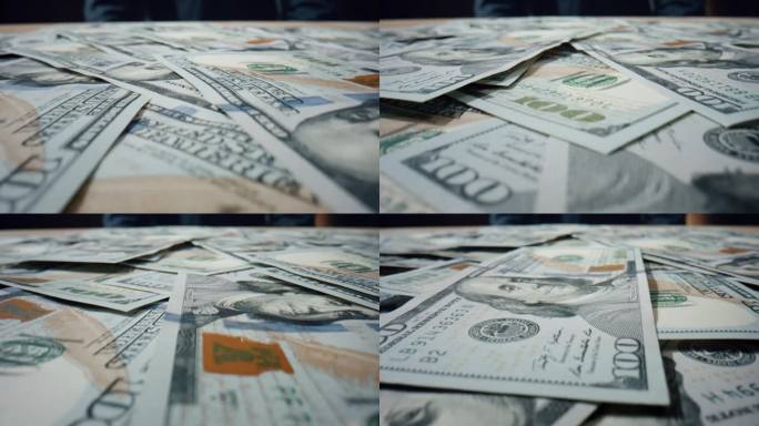 美元钞票堆积在一起。美国纸币散落在桌子上。