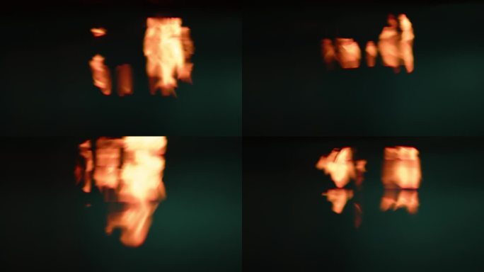 火焰反射水面的慢动作图案，黑色背景