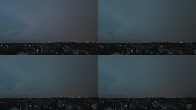 广角无人机拍摄的暴风雨云形成在阴暗的天空之前，大雨和闪电在郊区城镇地区。
