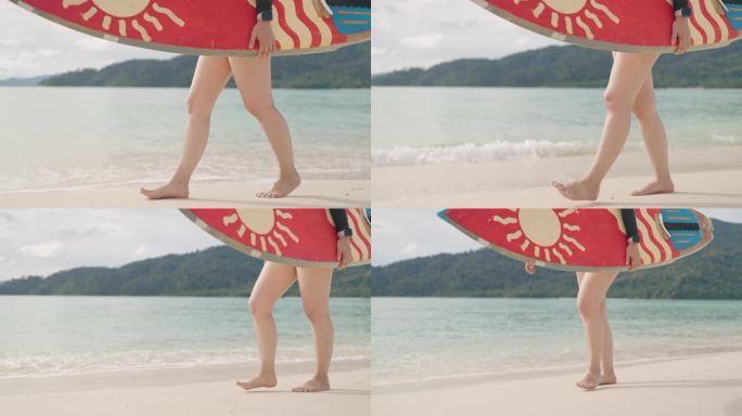 日落时分，一名女子在沙滩上拿着冲浪板