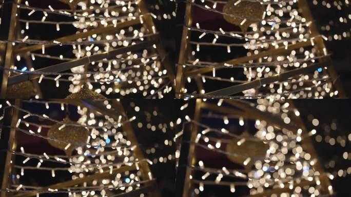圣诞树:一种装饰着装饰品的金属形状的户外圣诞装置图像逐渐模糊。