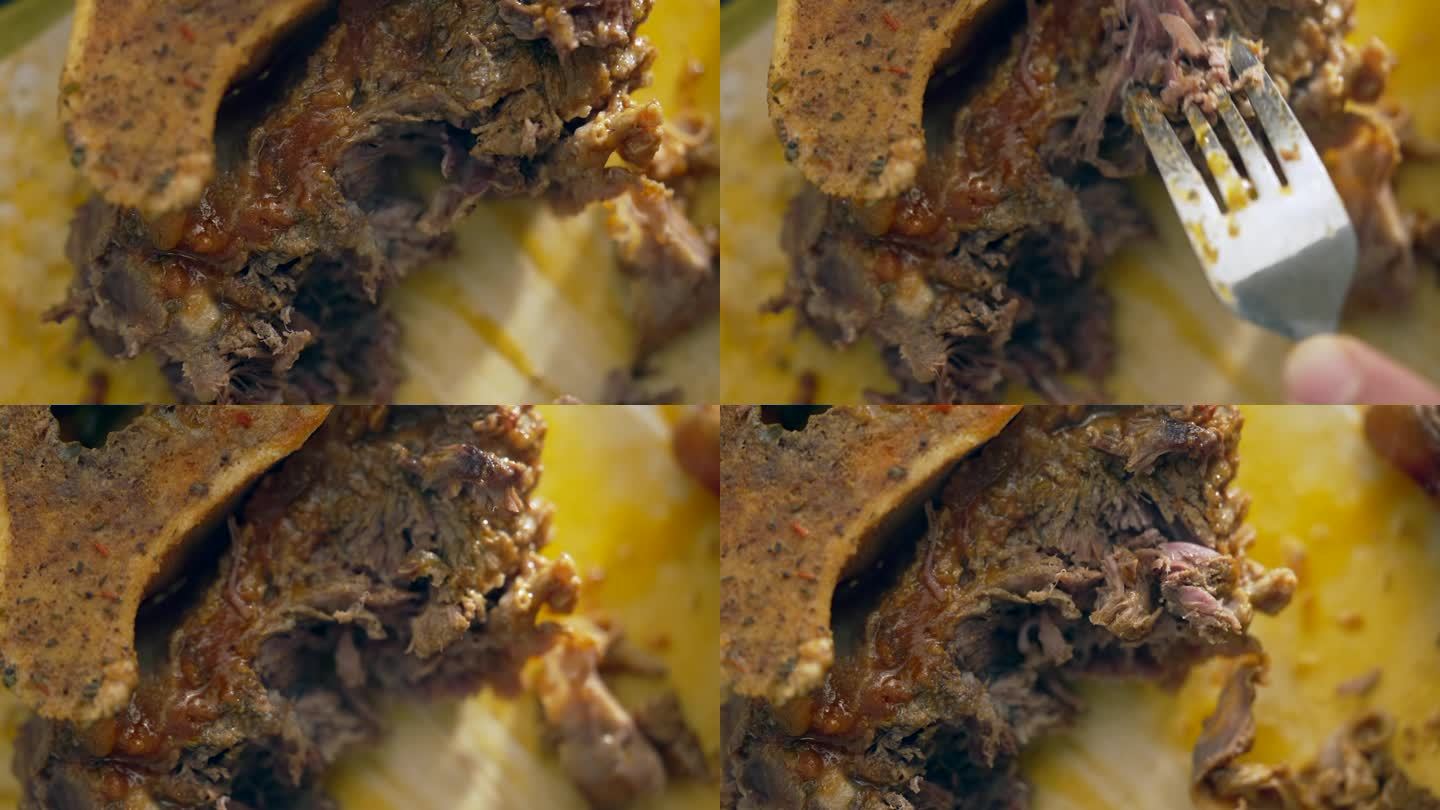 美食细节-叉子切碎牛膝肉在宏观食品准备，牛膝宏观特写烹饪场景，烹饪食物
