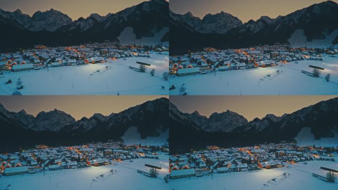 航拍黄昏时分，朱利安阿尔卑斯山的雪山环绕着克拉尼斯卡戈拉镇