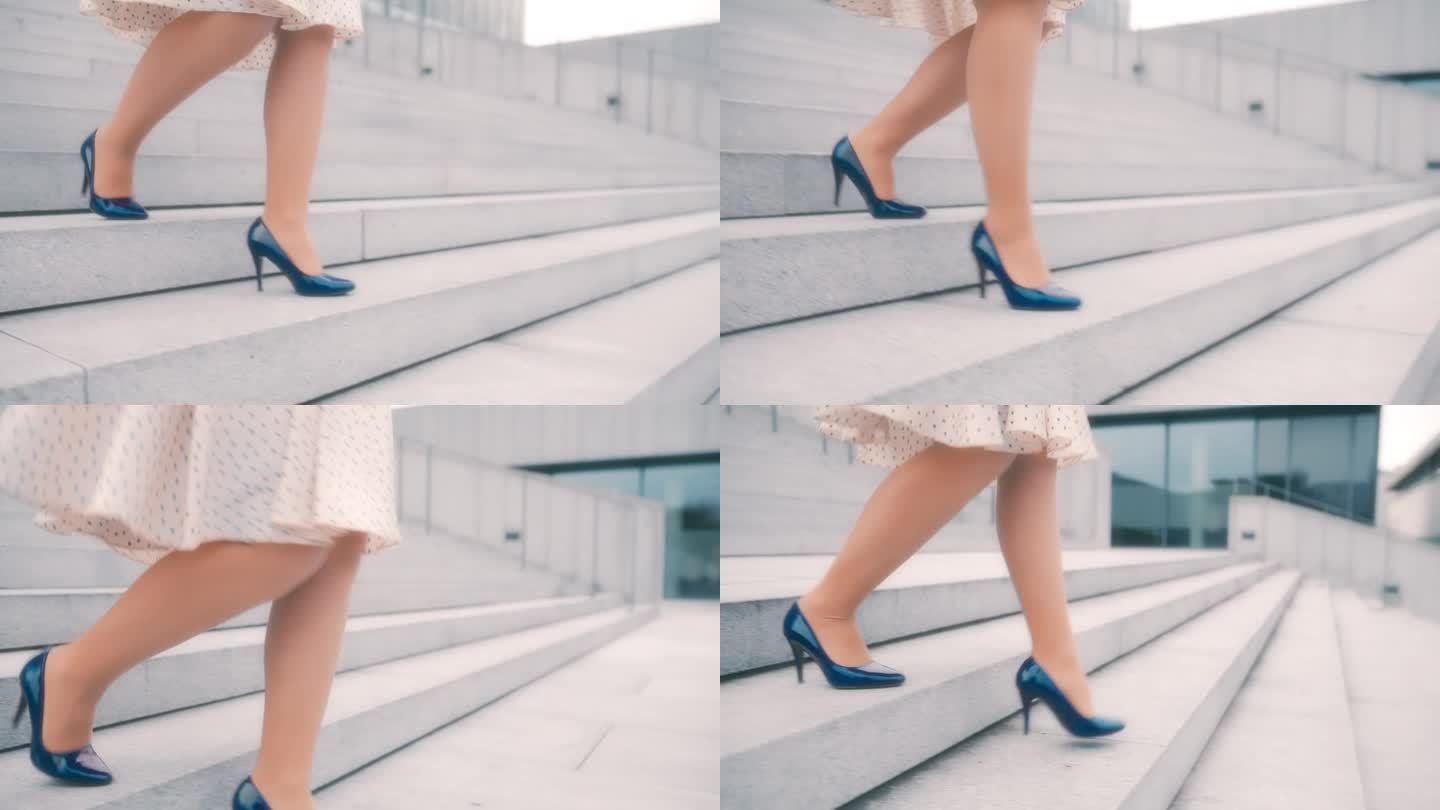 一个不知名的女人穿着裙子和蓝色细高跟鞋走下一座现代建筑前的楼梯