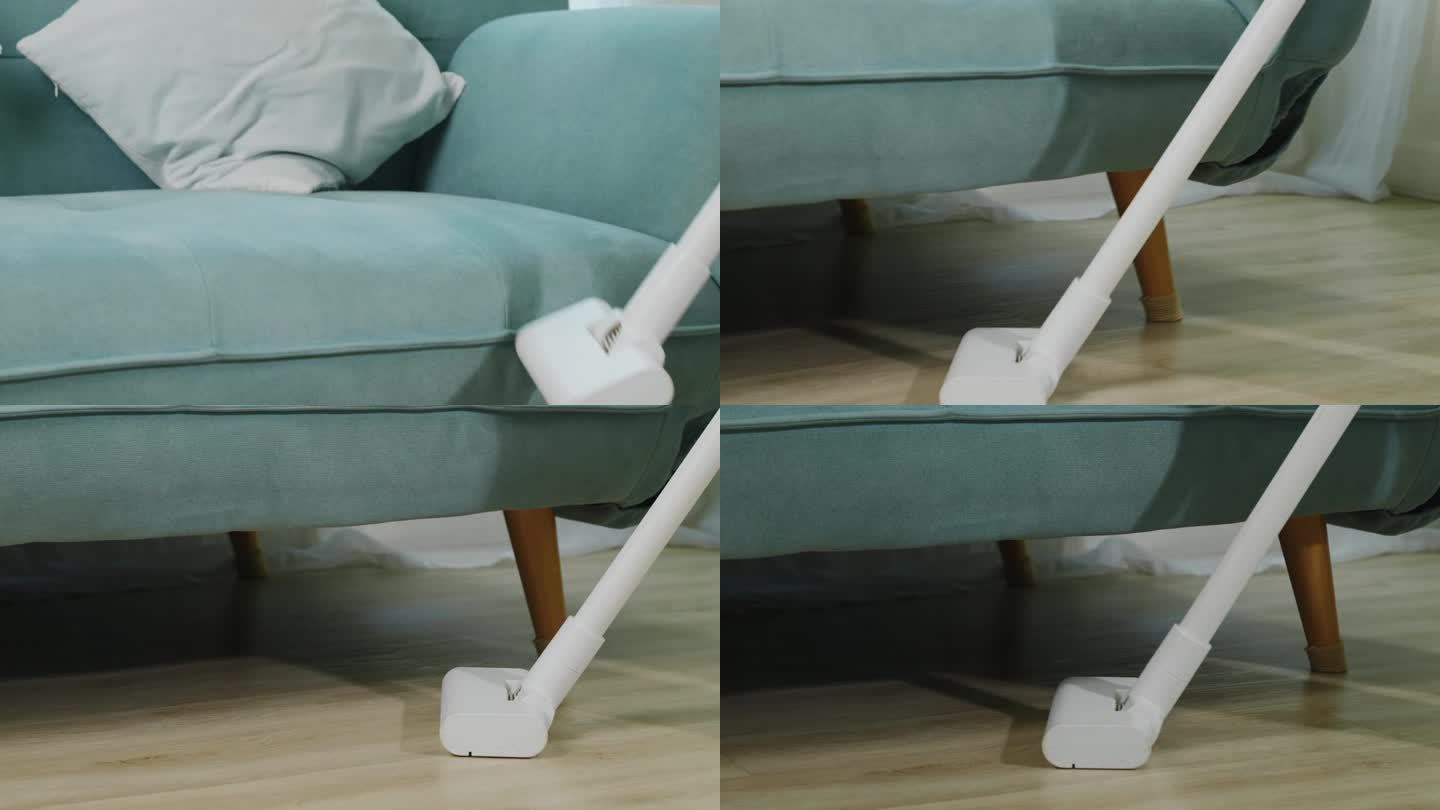 家庭主妇用吸尘器清洁沙发或沙发家具下面的地板