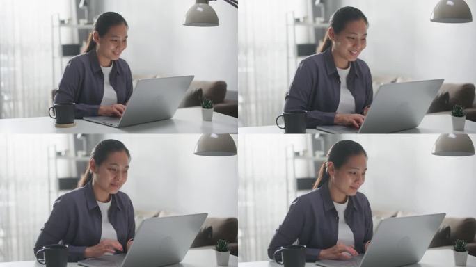 女人在家里使用笔记本电脑