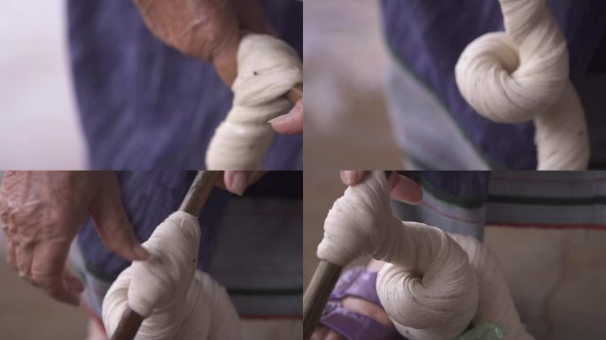 在农村生活中，妇女用一根棍子从棉纱中挤出水。
